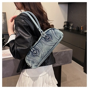 Detailed back view of a light blue washed denim crescent bag with vintage buckle and stitching