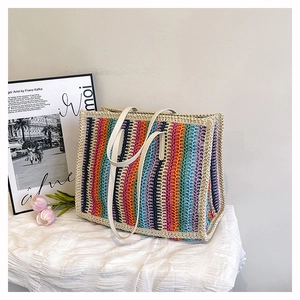 Detailed texture of a colorful rainbow woven tote bag with durable off-white handles
