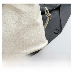 Close-up of cream white tote bag showing premium lychee texture leather detail