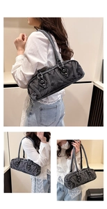 Detail of dark grey washed denim Boston bag with silver rivets and industrial stitching