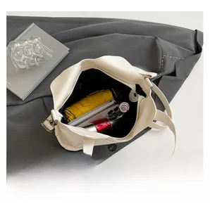 Interior view showing large capacity of the white pebble leather tote bag with daily items