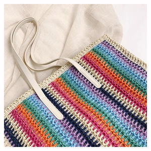 Detailed texture of rainbow woven straw tote bag with premium cream leather handles