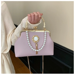 Close-up of lavender leather evening bag with pearl handle and golden vintage clasp
