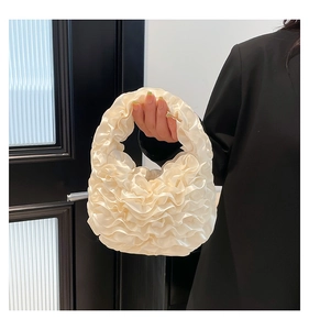 Detail of ruffled off-white satin handbag with elegant layered mesh pleated design