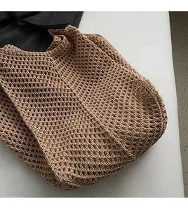 Close-up of light brown woven tote bag featuring a honeycomb crochet pattern texture