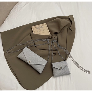 Silver glitter envelope chain bags set shown on a blazer with elegant metallic finish
