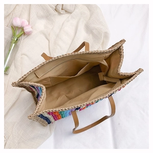 Macro view of the large rainbow straw tote bag interior with multiple storage pockets
