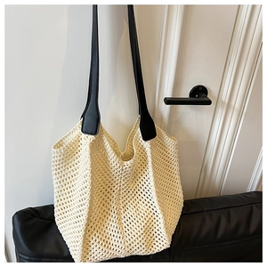 Close-up of cream crochet tote bag featuring intricate hollow diamond knit patterns