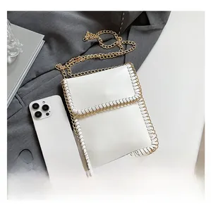 Vertical white leather phone bag with gold chain edge and matching thin shoulder strap