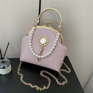 Pink shell bag with beaded handle and gold chain for elegant evening wear occasions