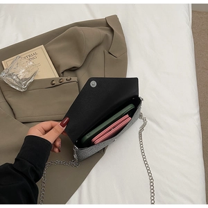 Detail of silver glitter chain bag interior showing space for phone and wallet