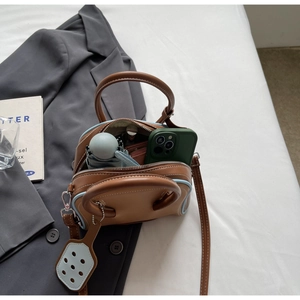 Detail of macaron bicolor bowling bag showing large interior space for daily items