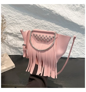 Pink lychee grain leather shell bag detail with silver studs and long tassels decoration