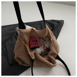 Macro detail of beige crochet tote bag showing hollow knit texture and spacious interior