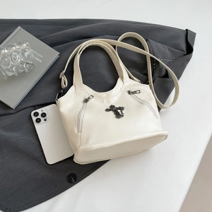 Cream pebble leather tote bag with vintage metal cross detail and top handles