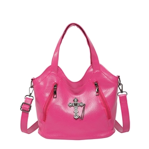 Retro fuchsia tote bag with metal cross detail and adjustable strap on white background