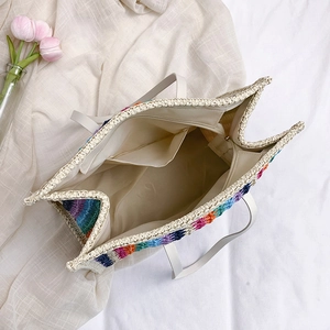 Rainbow woven straw tote bag with large capacity, white leather handles and zip closure