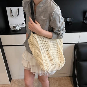 Minimalist woven crochet tote bag in beige with black leather strap for summer
