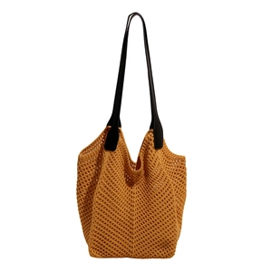 Caramel woven tote bag with black leather straps in a relaxed summer knit design