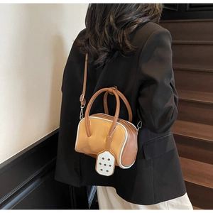 Chic macaron color blocking bowling bag with double handles and slim strap shown on model