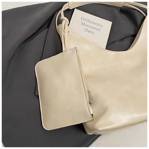 Detail view of cream white hobo bag set with matching detachable zipper pouch
