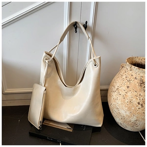 Detail view of large cream hobo tote bag with matching inner pouch and smooth texture