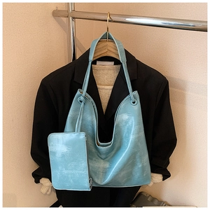 Close-up of light blue marble textured tote bag with matching zipper clutch set