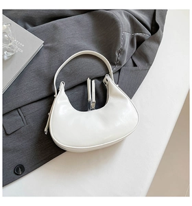 Detailed view of white half-moon hobo bag with sleek metal zipper and minimalist design