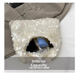 Internal view of white sequin shoulder bag showing capacity for lipstick and cosmetics