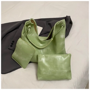 Detailed view of grass green tote bag set featuring vintage textured leather and drawstring
