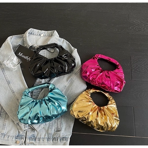 Set of pleated metallic handbags in black rose blue and gold on denim background