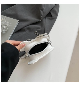 Top view detail of white mini crossbody bag interior with silver metal ball chain strap