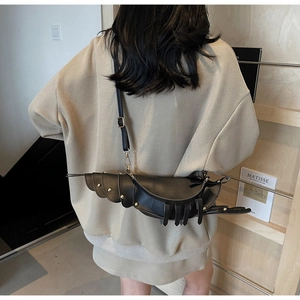Detailed back view of a black lobster-shaped leather crossbody bag with gold studs