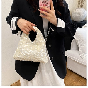 Detailed shot of shimmering pearl white sequin texture on a stylish evening handbag