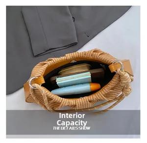 Internal capacity of woven shoulder bag showing phone and cosmetics space