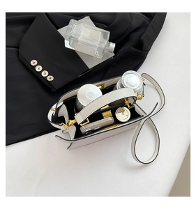 Interior view of white leather handbag showing large capacity and internal compartments