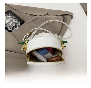 Detail shot of the open floral crossbody bag showing its interior capacity and white leather