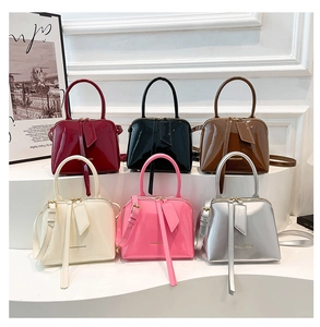Showcase of six colorful patent leather mini handbags with glossy finish and thin straps