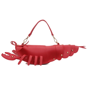 Creative red lobster-shaped handbag with gold metal studs and top handle on white background