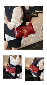 Detail view of burgundy glossy shoulder bag with metallic rivets and vintage buckle strap