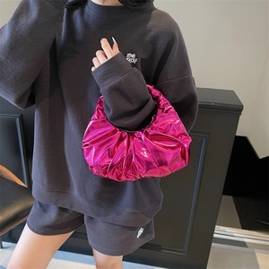 Metallic pink pleated handbag with crescent shape shown from a high-angle perspective