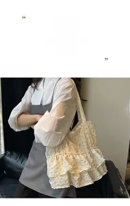 Detail of ruffle layers on a floral tote bag featuring yellow flower patterns