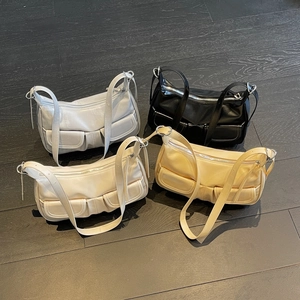 Minimalist crossbody bag set in silver, black, beige and yellow on wood surface