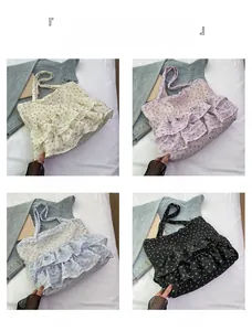 Detail view of floral tote bags in cream, purple, blue, and black with ruffled tiers