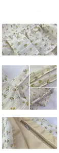 Detailed view of floral canvas tote fabric with zip closure and ruffled strap stitching