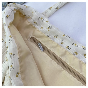 Close-up of floral tote bag interior featuring inner zipper pocket and dual-layer fabric