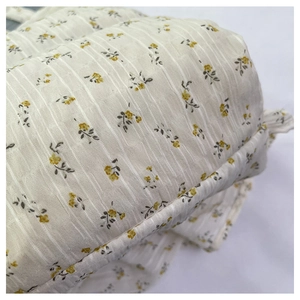 Macro detail of floral canvas fabric featuring yellow flowers and ribbed texture