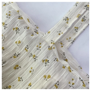 Detail of floral tote bag showing yellow flower print and textured seersucker fabric