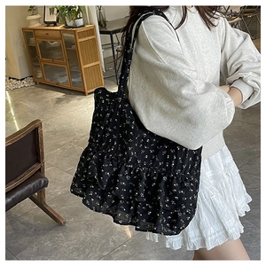 Detail of floral canvas tote bag with ruffle trim and wide shoulder straps