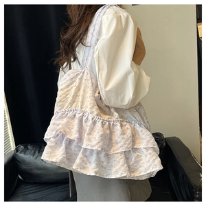 Detail of floral tote bag with layered ruffles and long shoulder straps for daily use
